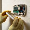 heater repair hvac tech repairing thermostat